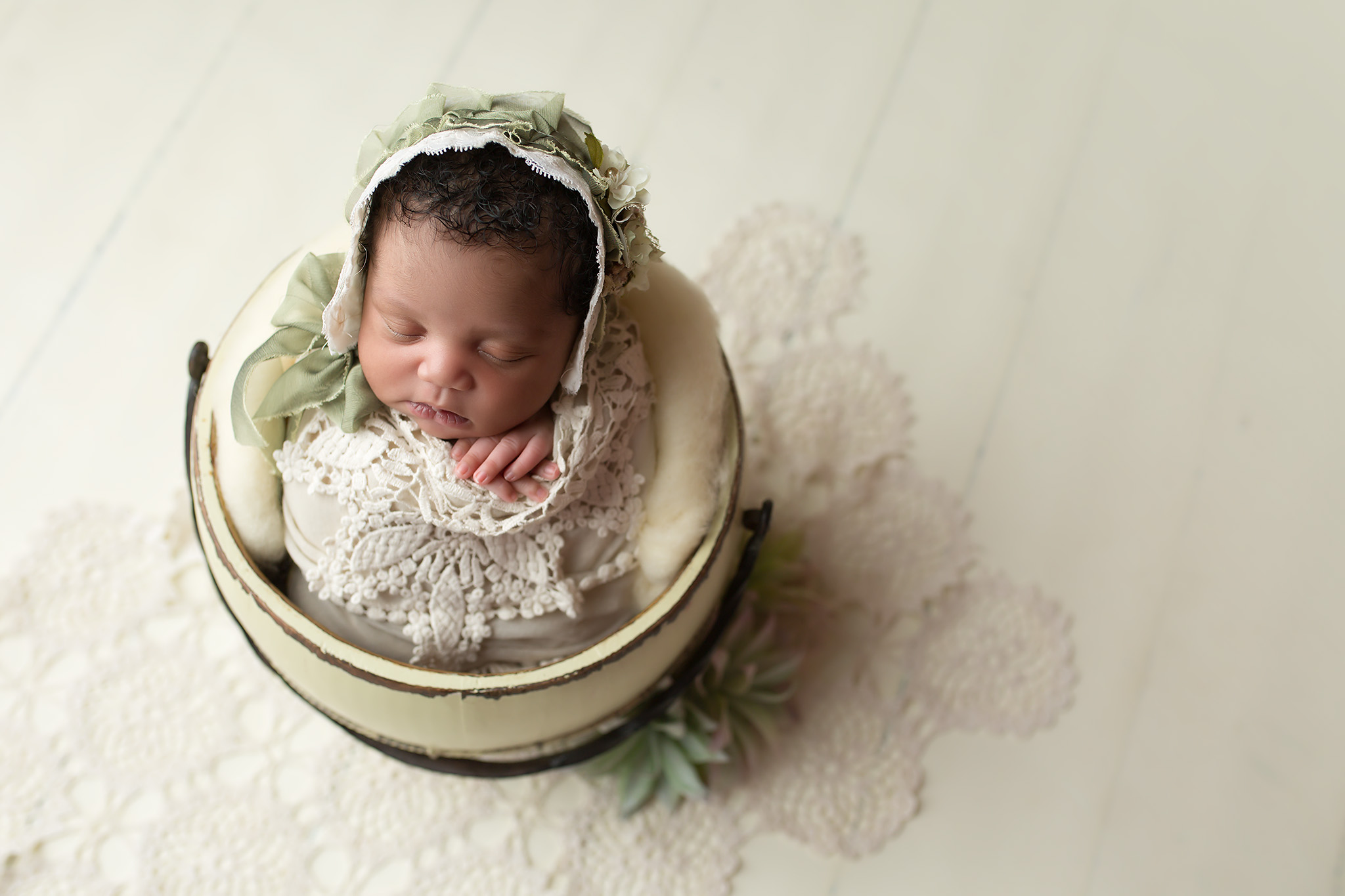 newborn girl in bucket