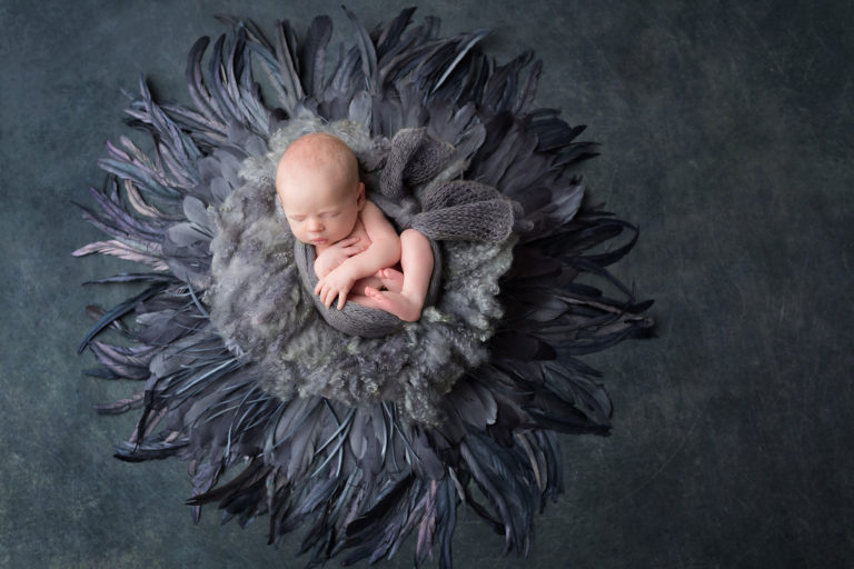 Newborn baby sleeping peacefully in a white blanket