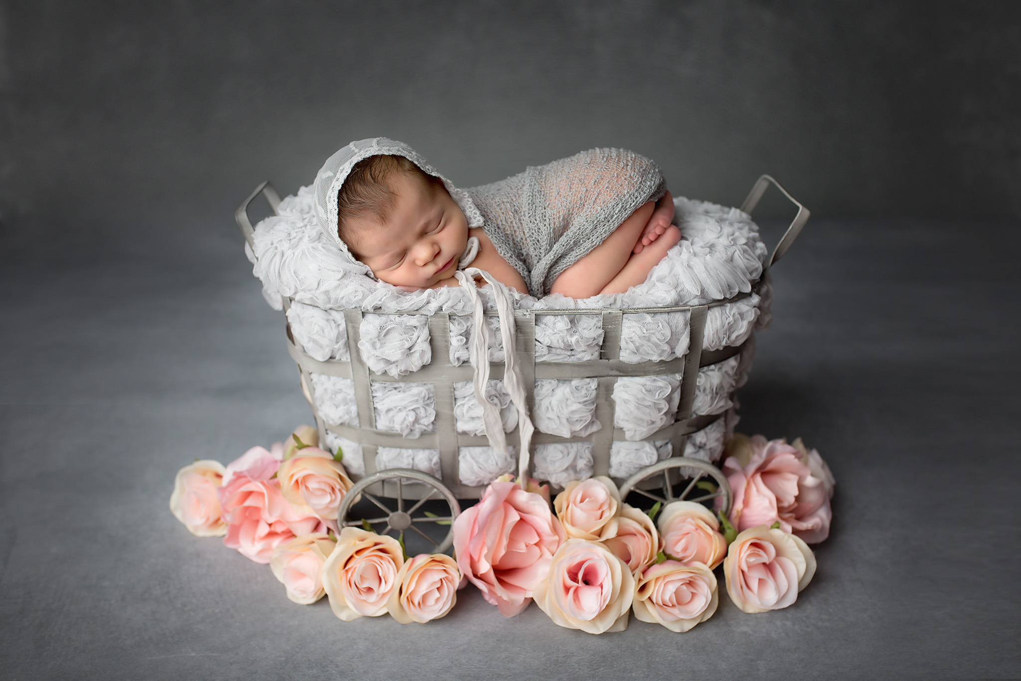 dallas newborn photographer baby in a basket with grey and pink