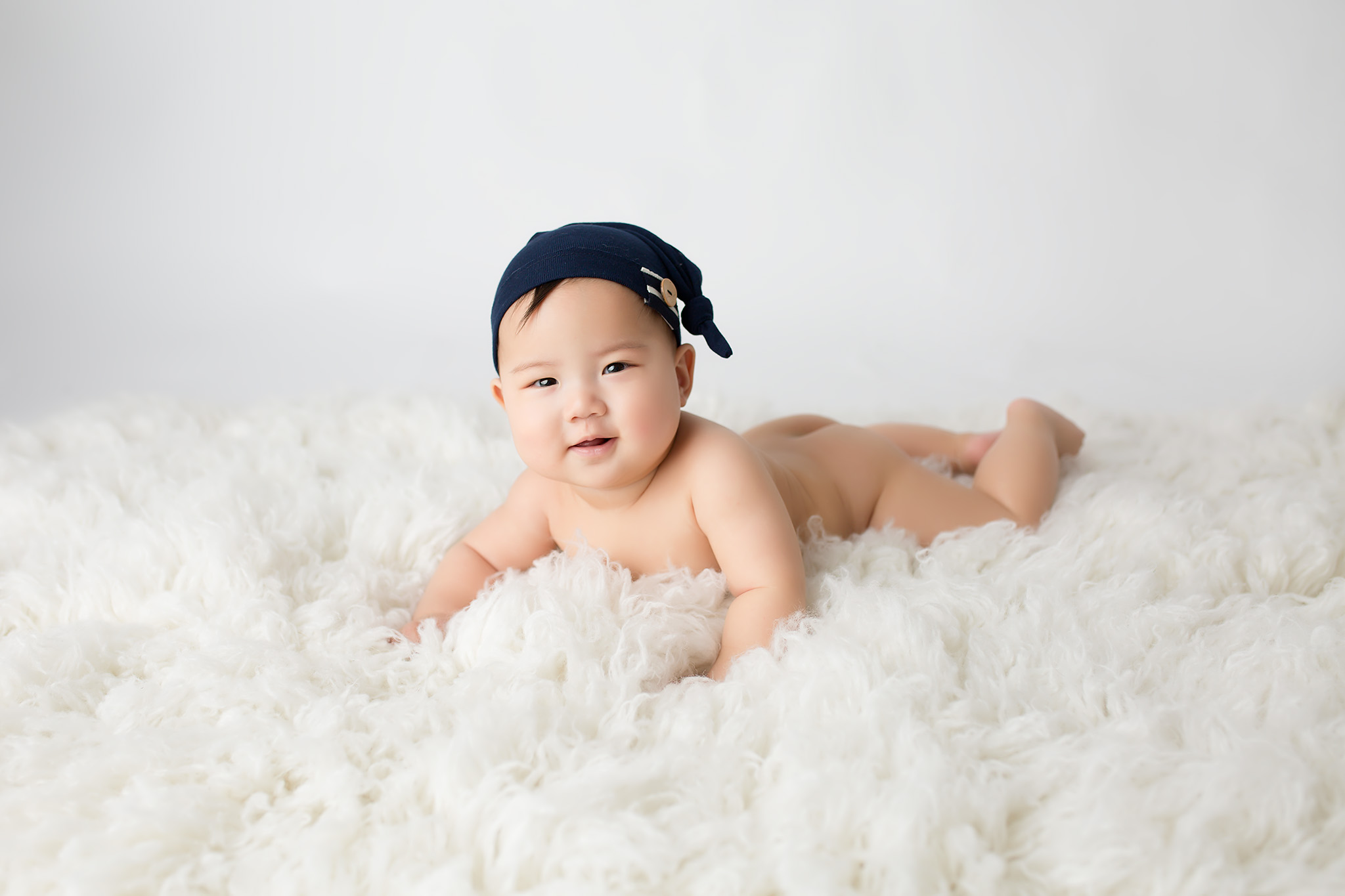 infant boy on white rug