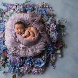 newborn girl in purple and blue