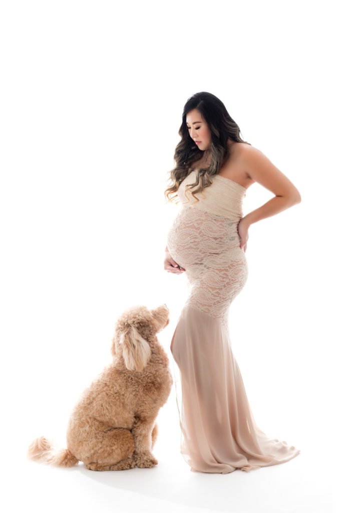 Pregnant woman in lace dress with dog