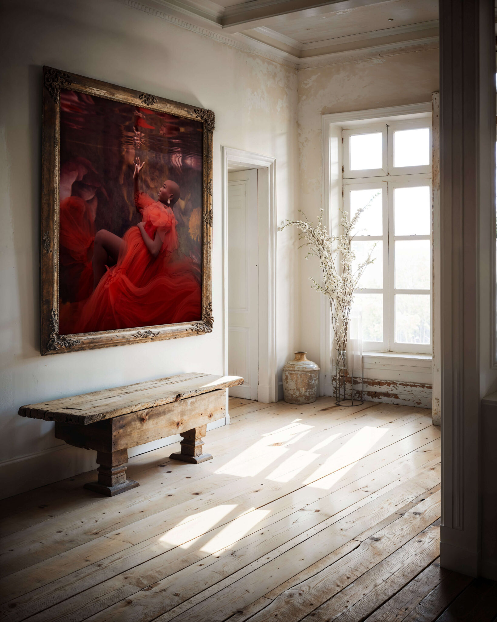A fine art portrait of a pregnant woman in a pool hangs in a rustic room