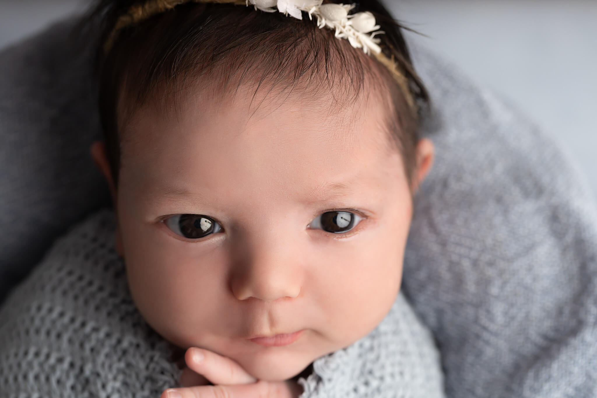 A newborn baby closeup with eyes open