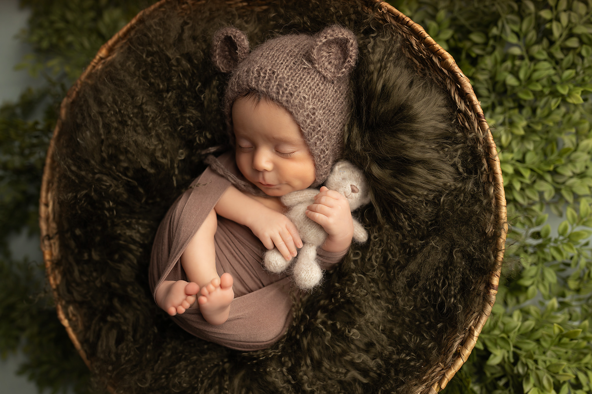 Baby boy sleeping in a bear onesie. Get your child to sleep with a baby sleep consultant in Dallas.